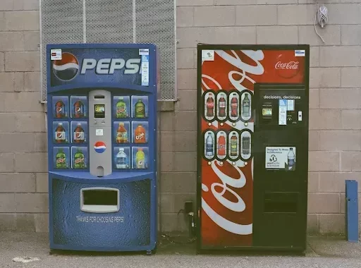 blue and red pepsi and cola vending machine